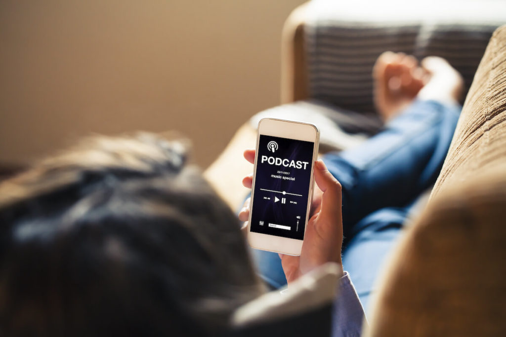 Person looking at a mobile podcast app