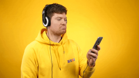 A GIF of a man listening to a podcast and nodding his head in approval