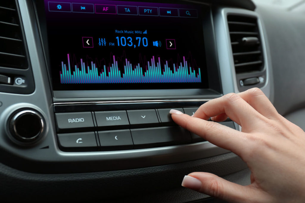 radio spots: woman adjusting the radio in her car