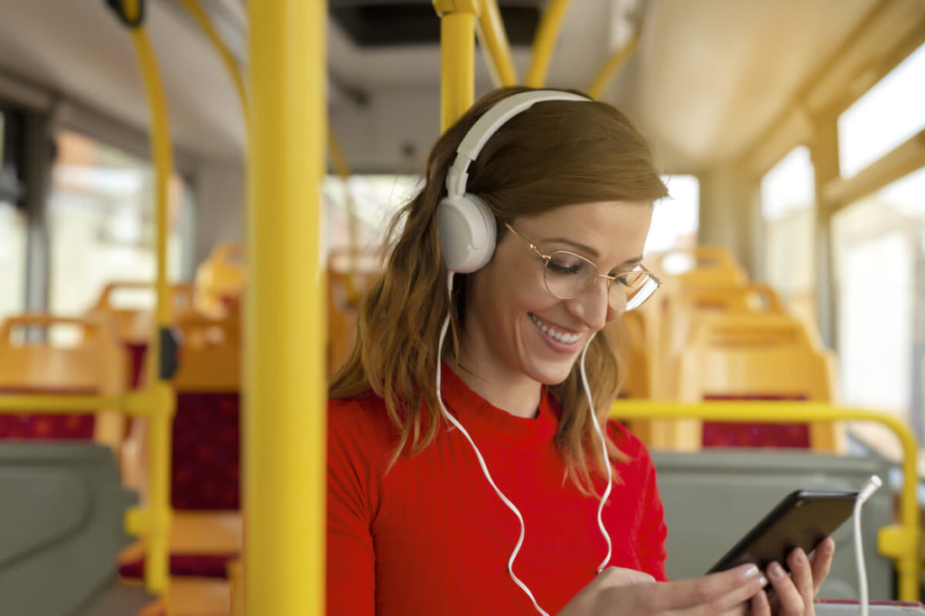 Spotify advertising: woman with headphones on using her mobile phone