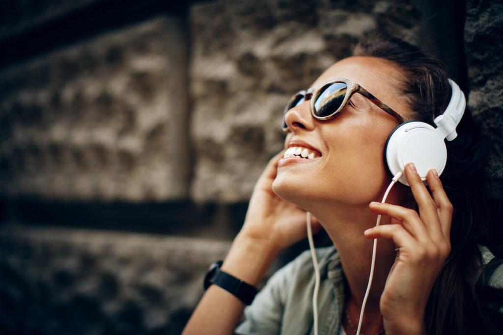 Mid roll: woman wearing headphones and sunglasses