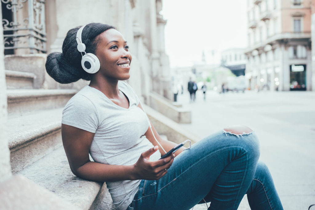 Spotify ad examples: woman wearing headphones and happily listening to music